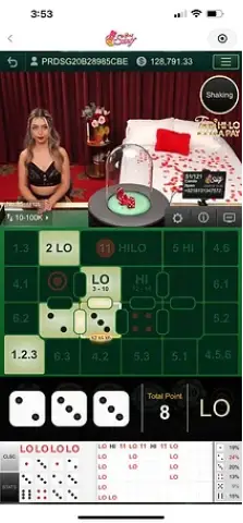 Winbox AE Sexy Thai HiLo live dealer hosting an elegant dice session in a red-themed studio.